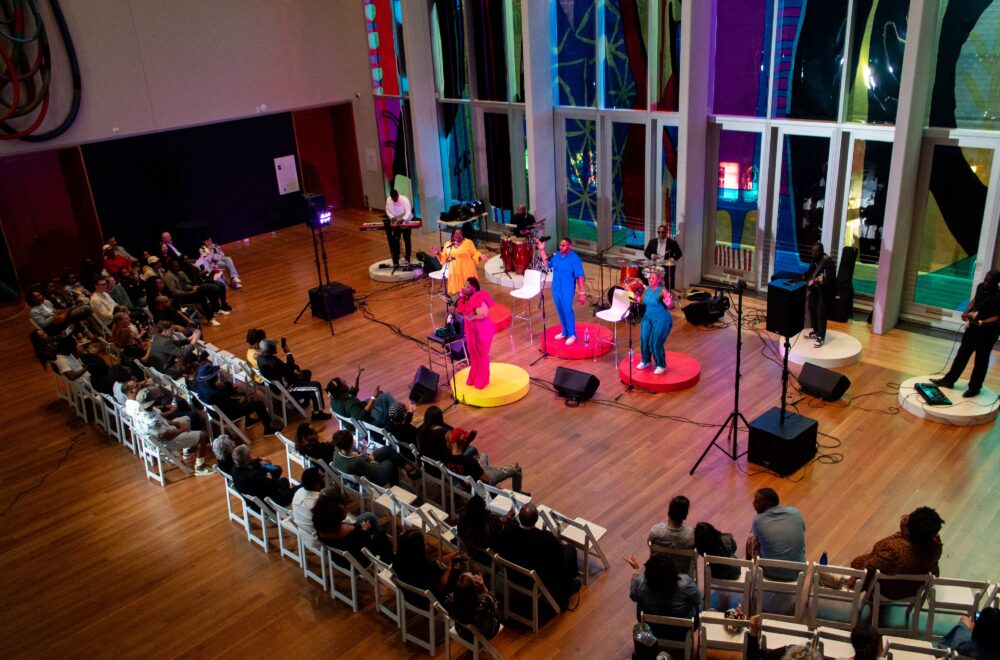 Jessica Macks and band performing in front of a crowd during Wednesday Night Live