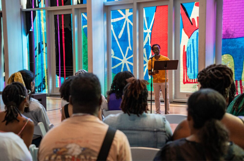 de'Angelo DIA reciting poetry in front of an audience at Wednesday Night Live