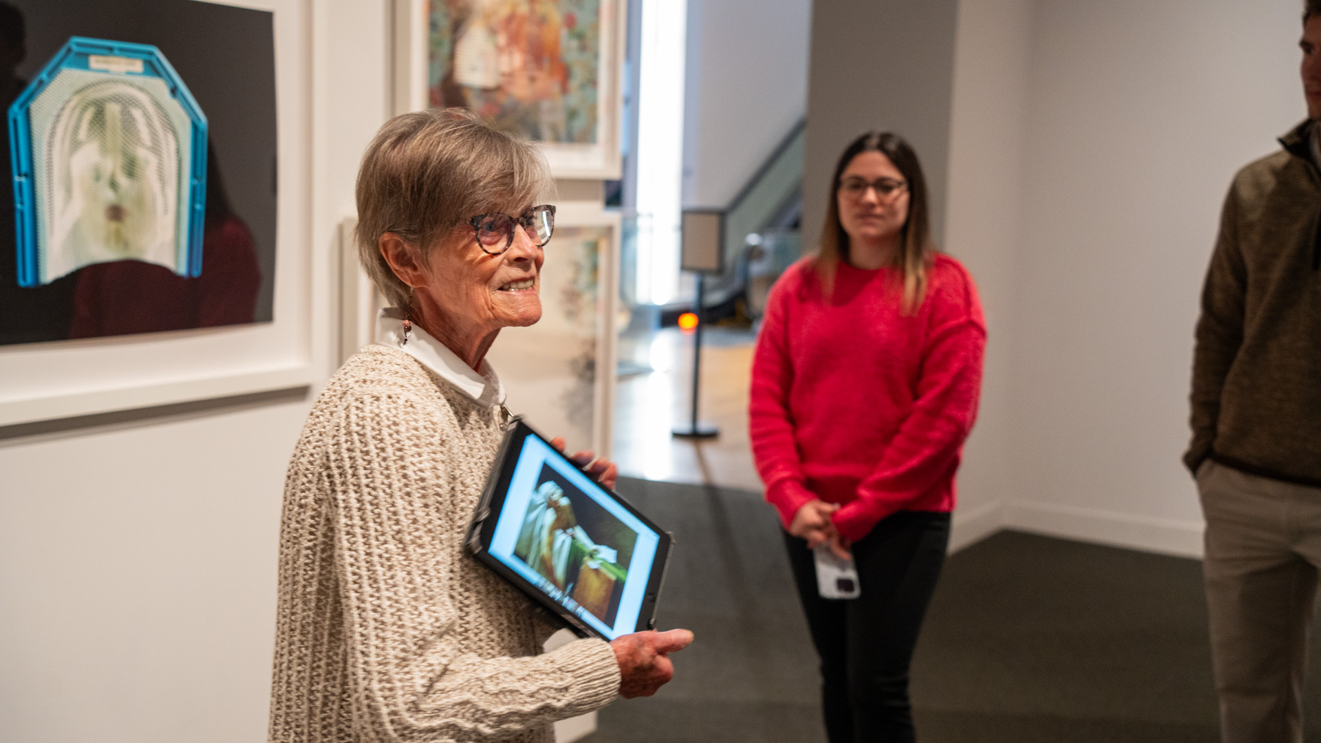 Docent with iPad speaking to group of people