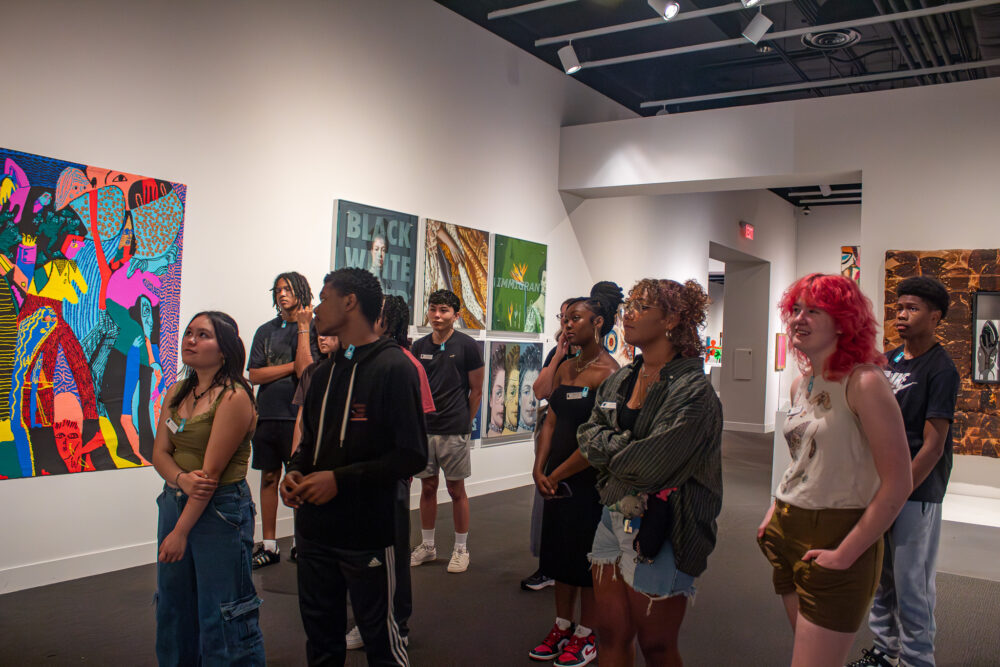 Group of teenagers listening to a docent in the galleries