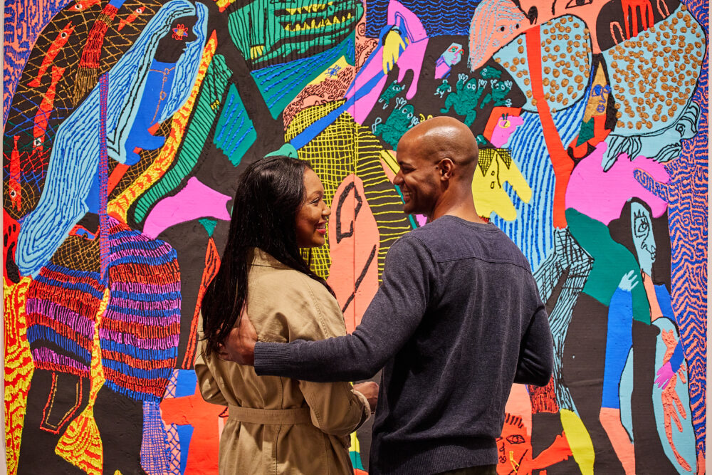 Couple looking at each other in front of art