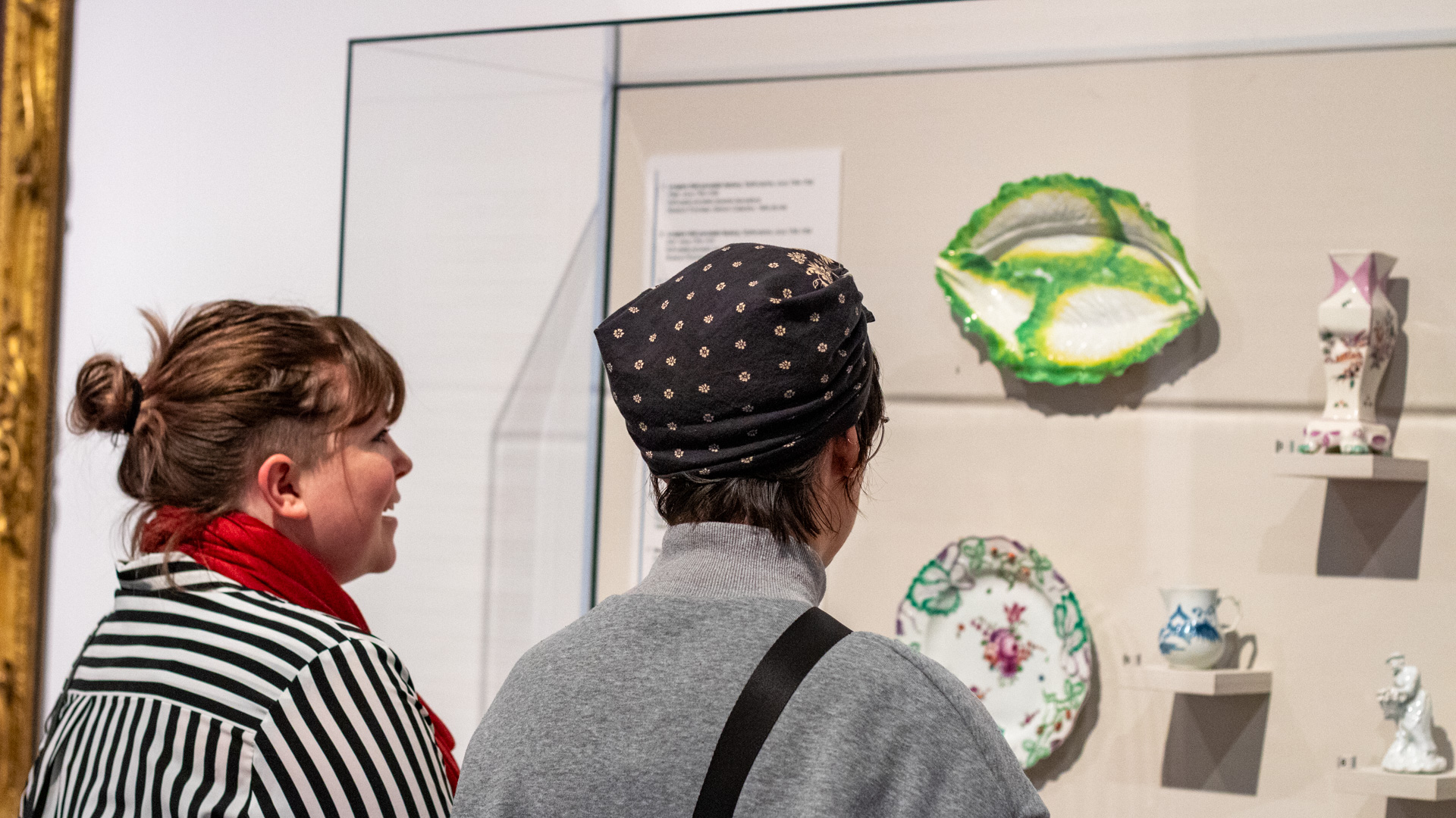 Two people looking at decorative art in our Randolph galleries