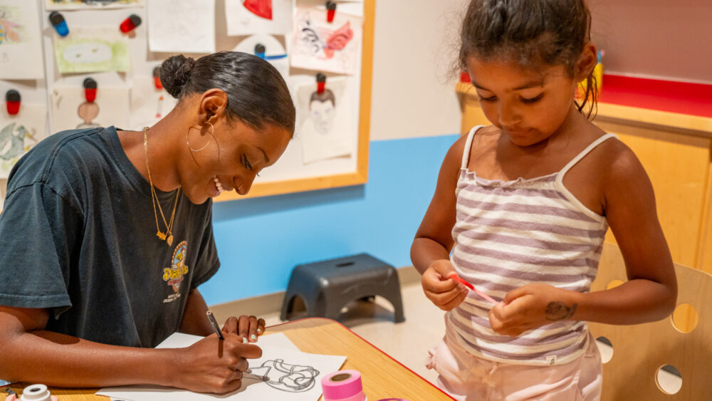 child and adult creating art in the Lewis Family Gallery at Mint Museum Uptown