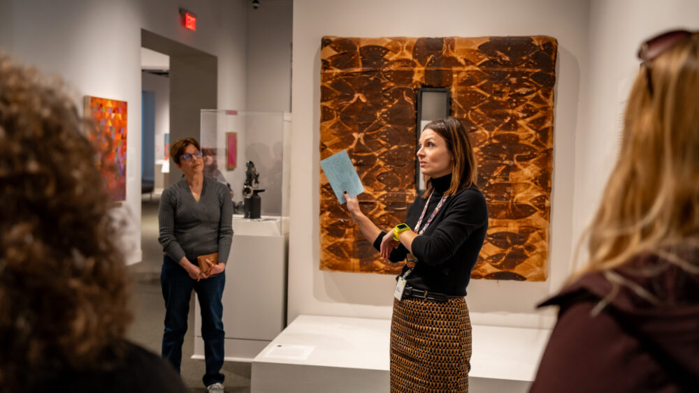 Docent speaking to group of people in the gallery